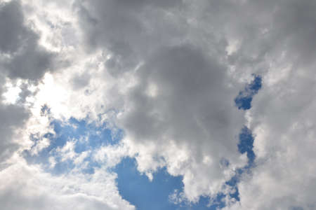 Clouds background. Blue sky with fluffy white clouds. Sunny day with beautiful weather.