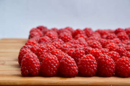 Raspberry organic background. Fresh raspberries from village garden. Ecological berries for desserts, cakes, smoothie or jam.の写真素材