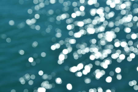 Bokeh ocean water. Deep blue sea. Waves far in open ocean. Dark blue sea water. Summer background. Ocean blur. Cruise theme. Swimming in the sea. Traveling and tropical resort concept.の写真素材