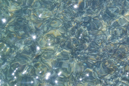 Sea water. Turquoise clear water. Summer background. Ocean water in sunny day. Tropical background.
