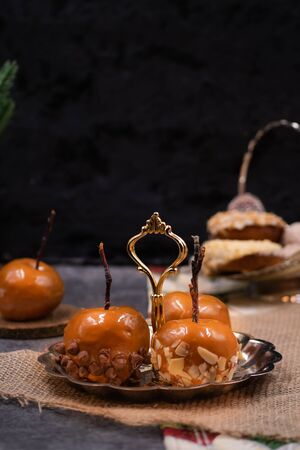 Festive caramel apples on silver serving plateの写真素材