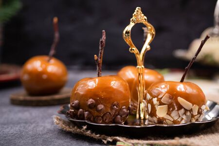Festive caramel apples on silver serving plateの写真素材