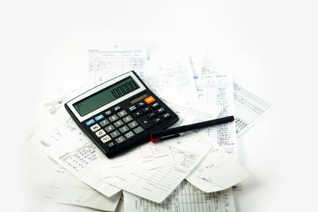Calculator, bills and pen in the white backgroundの写真素材