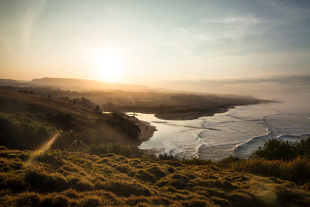 Sunrise on the beach and hills, Puncak Guha, Garut, West Java, Indonesiaの写真素材