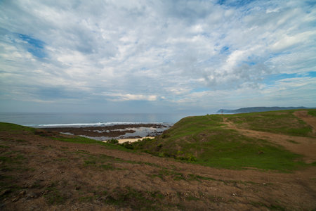 Views of the hill and the sea with blue skyの写真素材