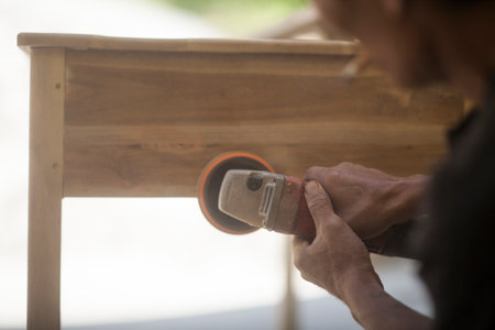 man will work wood with a grinding machineの写真素材