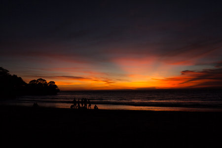 Silhouette Of people on sunset beachの写真素材