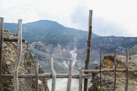 volcanic crater is limited by a wooden fenceの写真素材