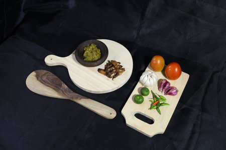 lime, squid, garlic, onion and green chili with a black backgroundの写真素材