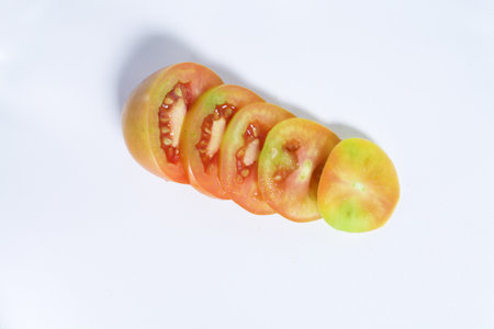 how to cut tomatoes into several parts with a white backgroundの写真素材