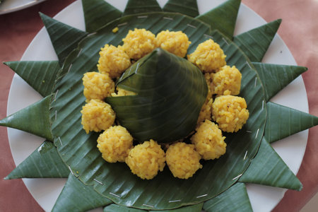 yellow rice with a star-shaped banana leaf baseの写真素材