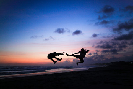 silhouette of people kickingの写真素材