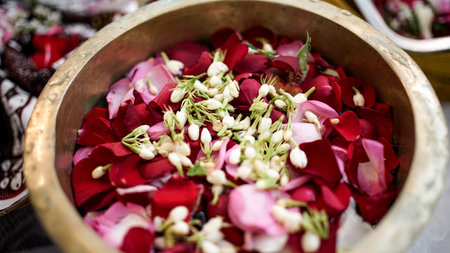 roses and jasmine in a bowl container during the splash ceremony before the wedding ceremonyの写真素材