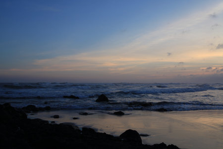 evening atmosphere on a scary beach with big wavesの写真素材