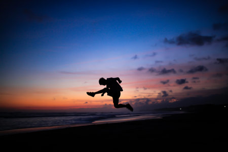 silhouette of people kicking legsの写真素材
