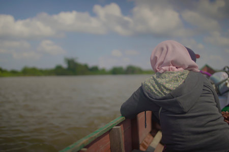 women residents ride traditional boats, North Kalimantan Indonesia