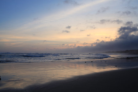afternoon atmosphere on the beach with a slightly orange skyの写真素材