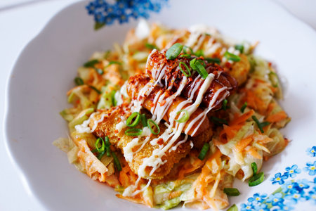 salad, chicken steak with mayo sauce and beef sausage sprinkled with scallionsの写真素材