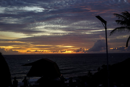 orange sky sunset with the silhouette of a campervanの写真素材