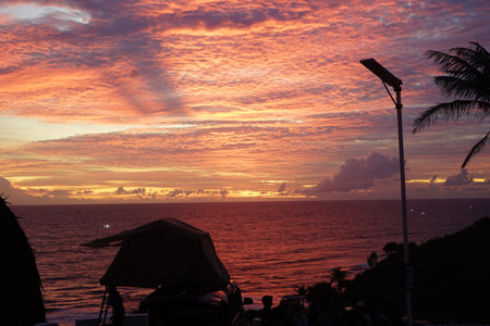 orange sky sunset with the silhouette of a campervanの写真素材