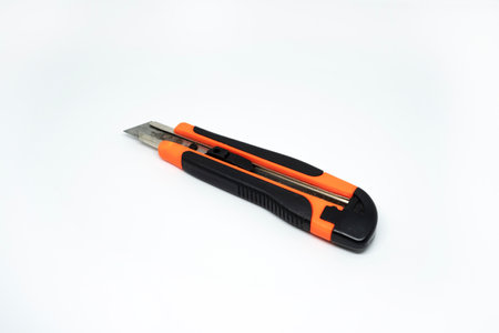 Closeup view of orange cardboard cutter isolated on white background. Box cutter isolatedの写真素材
