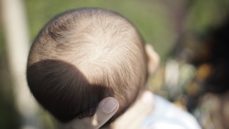 Close-up view of a baby's head showing soft hair