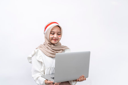 Person holding laptop and celebrating Indonesian independence day on 17 august isolated on white backgroundの写真素材