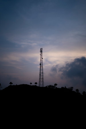 silhouette of Telecommunication tower Antenna at sunset on a hillの写真素材
