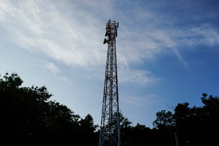 Signal tower or Mobile phone tower .Global connection and internet network concept on blue sky.