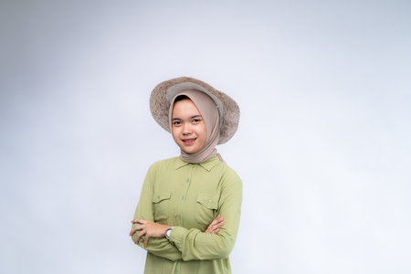 Portrait of young asian woman wearing hijab looking at the camera and standing isolated over white studio backgroundの写真素材