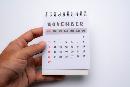hand holding desk calendar showing november monthの写真素材