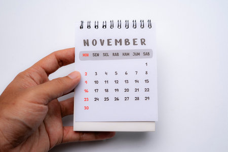 hand holding desk calendar showing november monthの写真素材