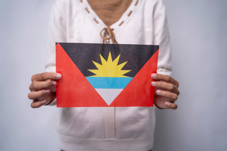 Person Holding the Flag of Antigua and Barbuda with Prideの写真素材