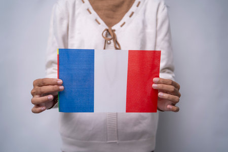 Person Holding the Flag of France with Prideの写真素材