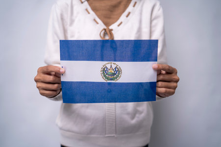 Person Holding the Flag of El Salvador with Prideの写真素材