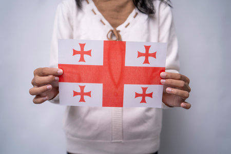 Person Holding the Flag of Georgia with Prideの写真素材