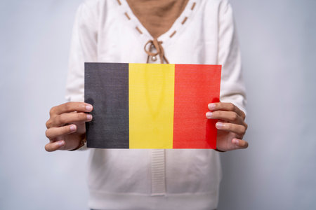 Person Holding the Flag of Belgium with Prideの写真素材