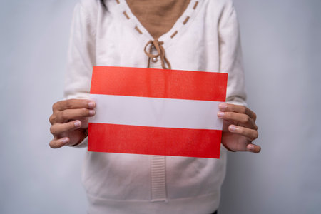 Person Holding the Flag of Austria with Prideの写真素材