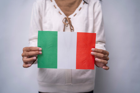 Person Holding the Flag of Italy with Prideの写真素材