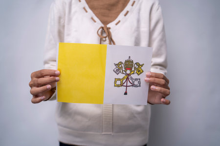 Person Holding the Flag of Vatican City with Prideの写真素材