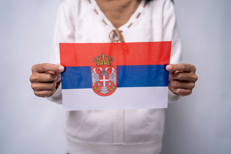 Person Holding the Flag of Serbia with Prideの写真素材