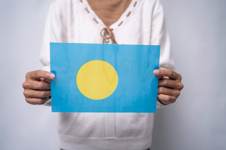 Person Holding the Flag of Palau with Prideの写真素材