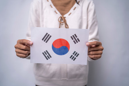 Person Holding the Flag of South Korea with Prideの写真素材