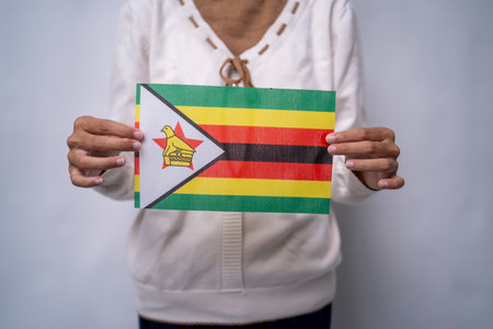 Person holding the national flag of Zimbabweの写真素材