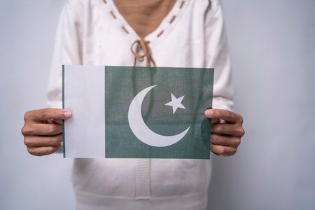 A person holding the flag of Pakistan with pride, symbolizing patriotism, unity, and national identity. The image reflects love for the homeland and respect for Pakistani culture and heritageの写真素材