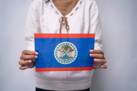 A person holding the flag of Belize with pride, symbolizing patriotism, unity, and national identity. The image reflects love for the homeland and appreciation for Belizean culture and heritageの写真素材