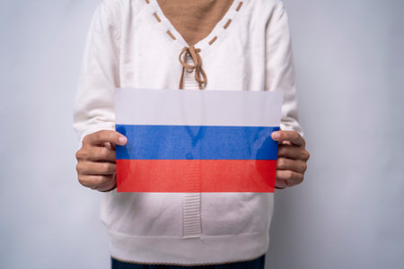 A person holding the flag of Russia with pride, symbolizing national unity, strength, and heritage. The image reflects patriotism and respect for Russian culture and historyの写真素材