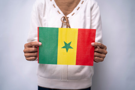 A person holding the flag of Senegal with pride