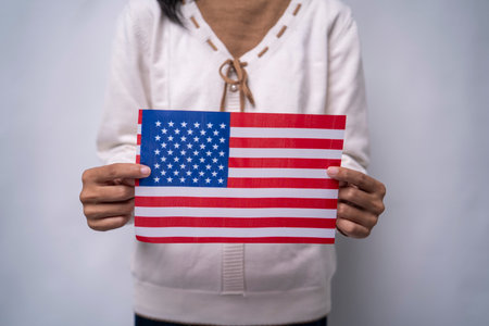 A person holding the flag of United States with prideの写真素材