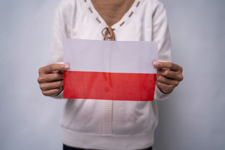 A person holding the flag of Poland with prideの写真素材